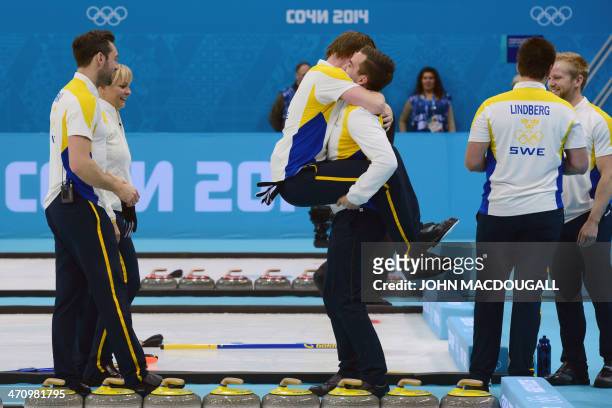 Sweden's Fredrik Lindberg and teammates celebrate after winning the men's Bronze medal match between Sweden and China at the Ice Cube curling centre...