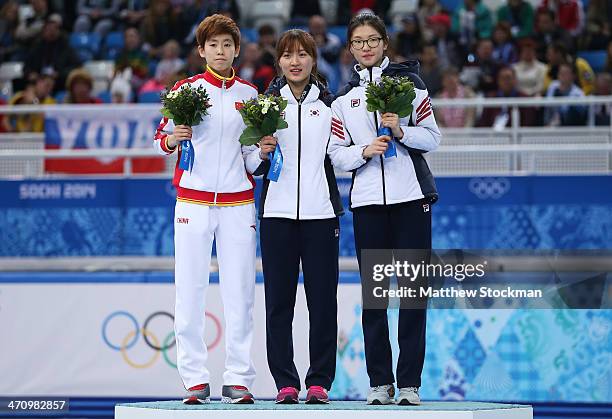 Silver medalist Kexin Fan of China, gold medalist Seung-Hi Park of South Korea and bronze medalist Suk Hee Shim of South Korea celebrate on the...