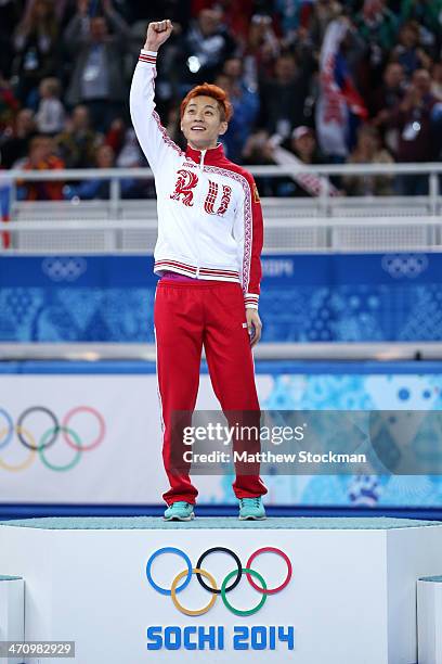 Gold medalist Victor An of Russia celebrates during the flower ceremony for the Short Track Men's 500m on the podium during the flower ceremony for...