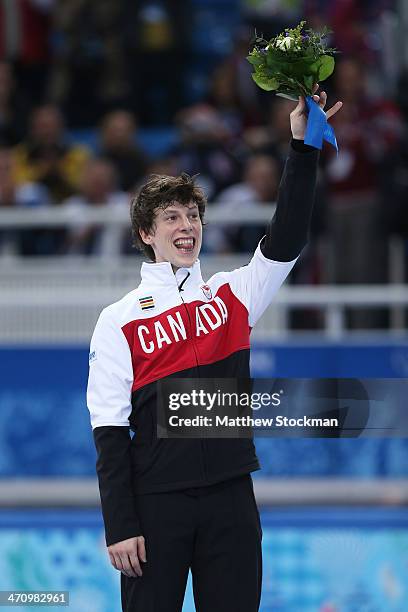 Bronze medalist Charle Cournoyer of Canada celebrates during the flower ceremony for the Short Track Men's 500m on day fourteen of the 2014 Sochi...