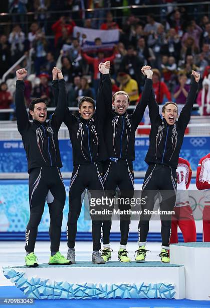 Silver medalist the United States celebrate on the podium during the flower ceremony for the Men's 5000m Relay on day fourteen of the 2014 Sochi...