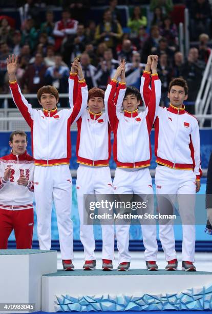 Bronze medalist China celebrate on the podium during the flower ceremony for the Men's 5000m Relay on day fourteen of the 2014 Sochi Winter Olympics...