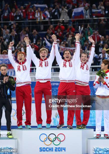 Gold medalist Russia celebrate during the flower ceremony for the Men's 5000m Relay on day fourteen of the 2014 Sochi Winter Olympics at Iceberg...