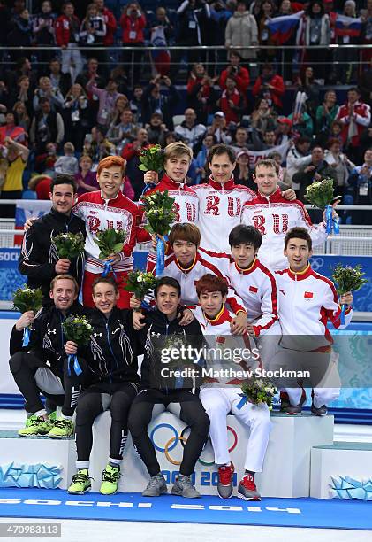 Silver medalist the United States, gold medalists Russia and bronze medalist China celebrate on the podium during the flower ceremony for the Men's...