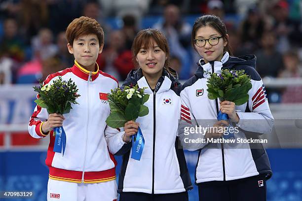 Silver medalist Kexin Fan of China, gold medalist Seung-Hi Park of South Korea and bronze medalist Suk Hee Shim of South Korea celebrate on the...