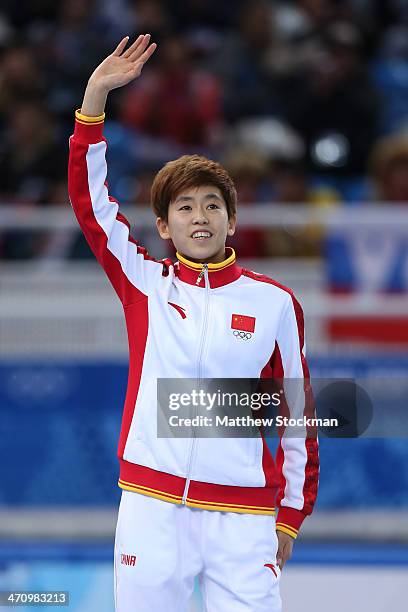 Silver medalist Kexin Fan of China celebrates during the flower ceremony for the Short Track Women's 1000m on day fourteen of the 2014 Sochi Winter...