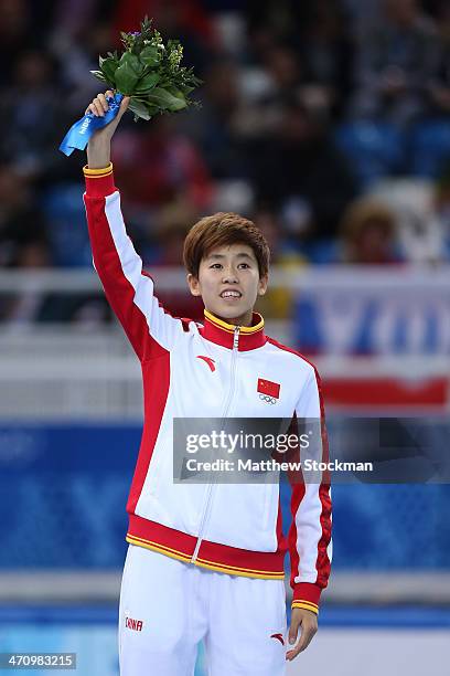 Silver medalist Kexin Fan of China celebrates during the flower ceremony for the Short Track Women's 1000m on day fourteen of the 2014 Sochi Winter...