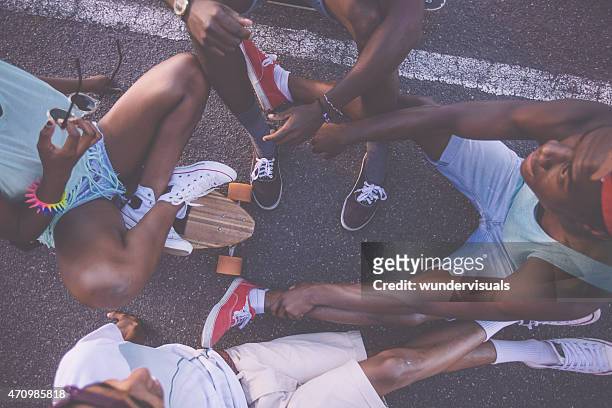 group of skater friends sitting in a circle on longboards - friends skating stock pictures, royalty-free photos & images