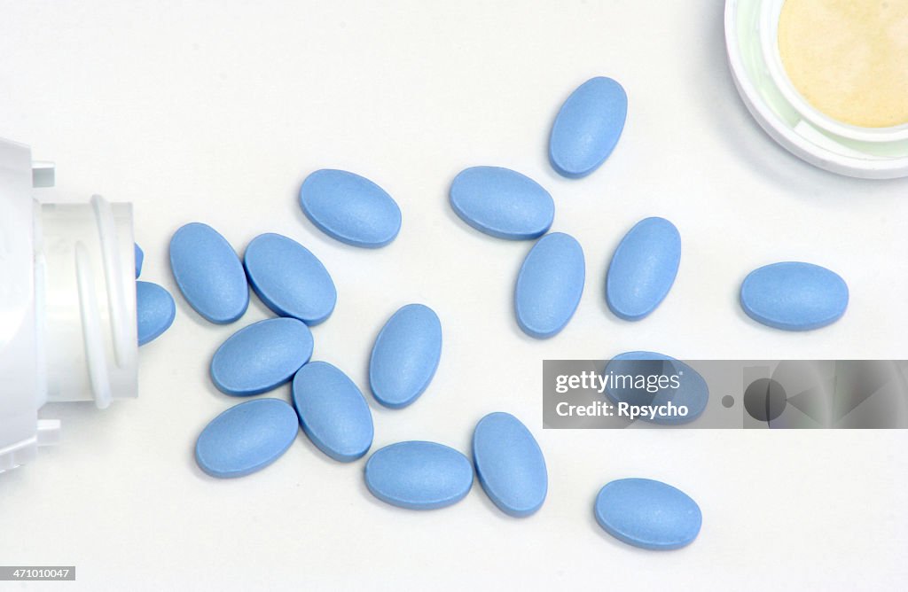 Blue pills spilled out from a bottle