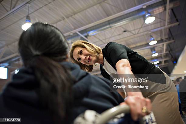 Carly Fiorina, former chief executive officer of Hewlett-Packard Co. And likely Republican presidential candidate for 2016, right, speaks with an...