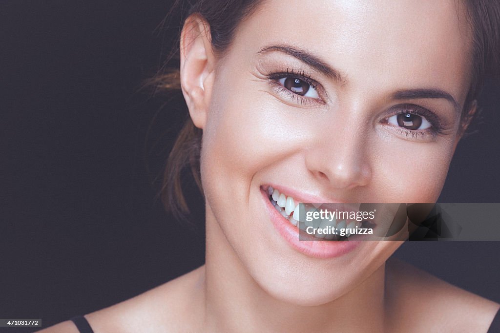 Natural young woman with perfect smile and clean healthy skin