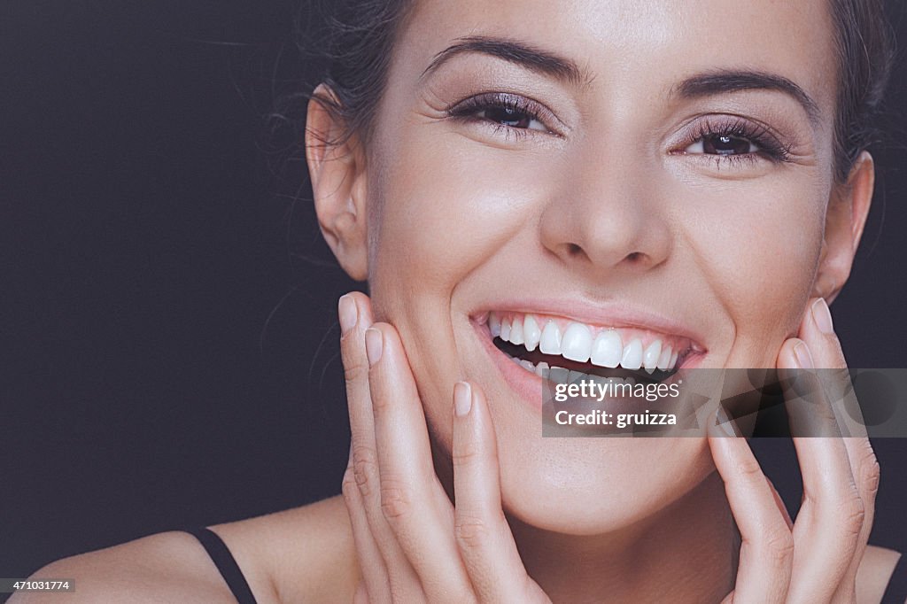 Natural young woman with perfect smile and clean healthy skin