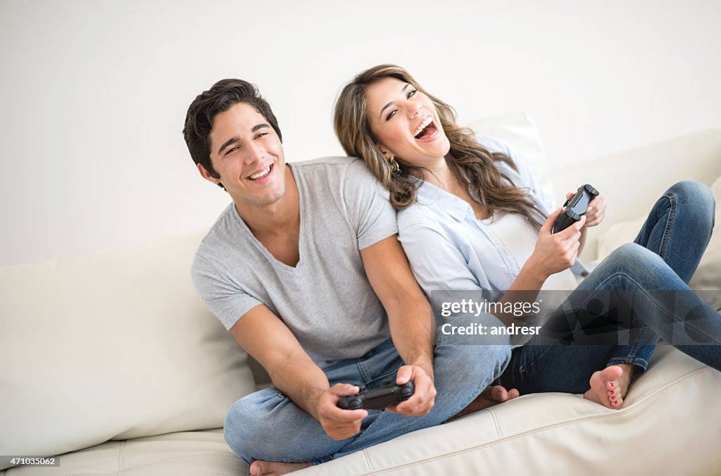 Couple having fun playing videogames