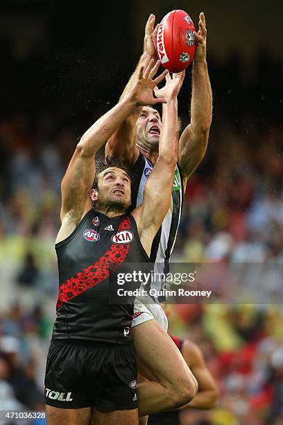 Travis Cloke of the Magpies marks over the top of Jobe Watson of the Bombers during the round four AFL match between the Essendon Bombers and the...