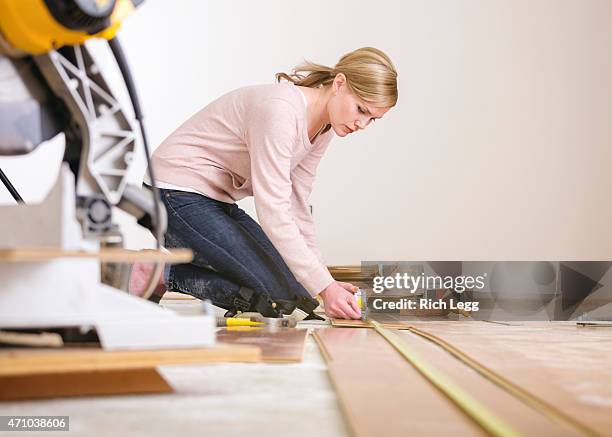 woman installing laminate flooring - wooden floor low angle stock pictures, royalty-free photos & images