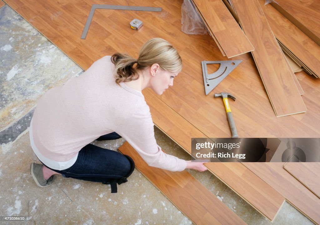 Woman Installing Laminate Flooring
