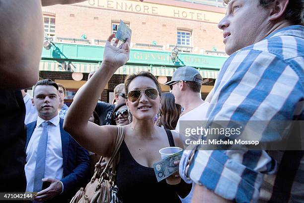 Day - Crowds at the Glenmore Hotel in the Rocks to play two Up on April 25, 2015 in Sydney, Australia. 2 Pennies are placed on a paddle and tossed in...