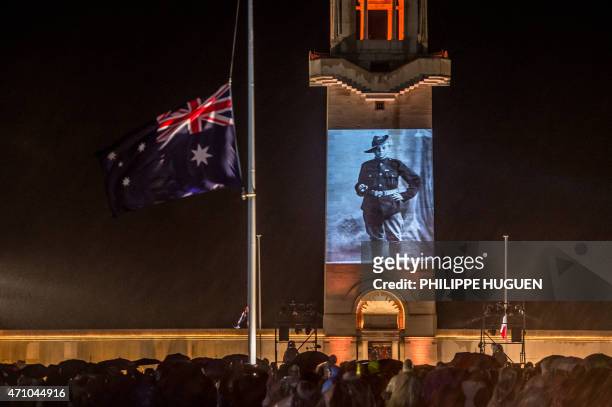 People attend a dawn ceremony marking the 100th anniversary of ANZAC Day at the Australian National Memorial on April 25, 2015 in Villers-Bretonneux,...