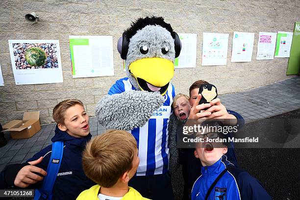 Fans pose for a selfie with the Brighton Mascot ahead of the Sky Bet Championship match between Brighton & Hove Albion and Watford at Amex Stadium on...