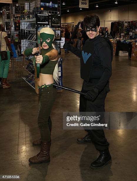 Vanessa Tullis of Kansas, dressed as Artemis from the "Young Justice" television show, and her husband, Nathan Tullis of Kansas, dressed as Nightwing...