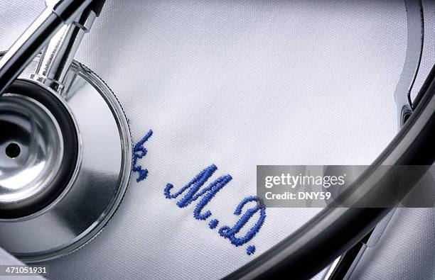 close up of a stethoscope and embroidery on a doctor's jacket - embroidery bildbanksfoton och bilder