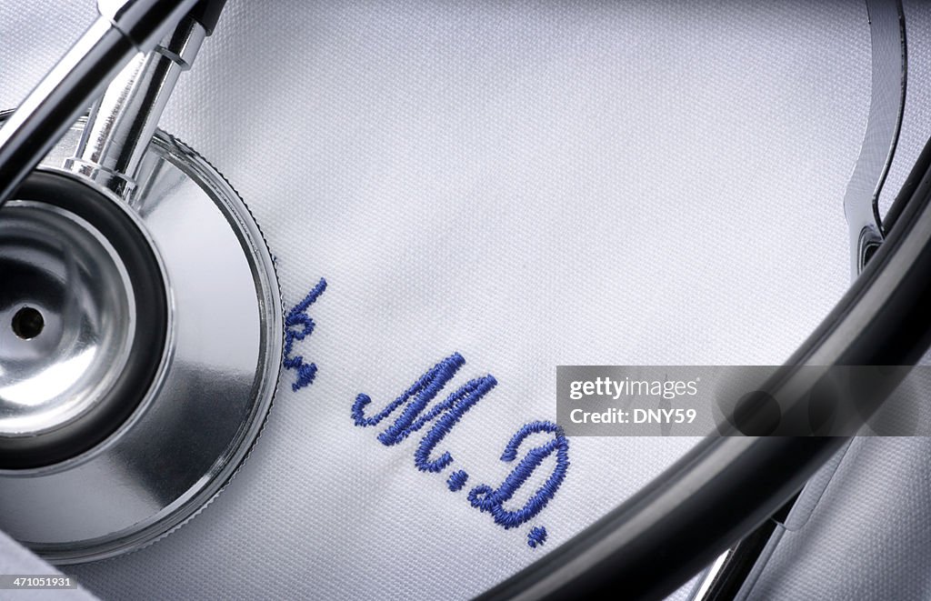 Close up of a stethoscope and embroidery on a doctor's jacket