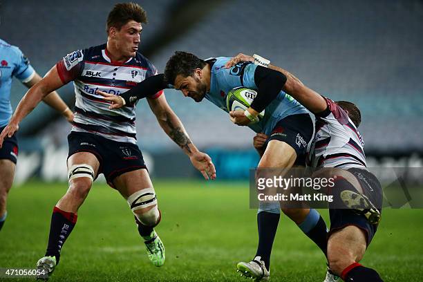 Adam Ashley-Cooper of the Waratahs is tackled during the round 11 Super Rugby match between the Waratahs and the Rebels at ANZ Stadium on April 25,...