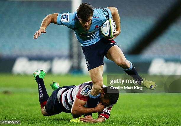 Rob Horne of the Waratahs is tackled during the round 11 Super Rugby match between the Waratahs and the Rebels at ANZ Stadium on April 25, 2015 in...