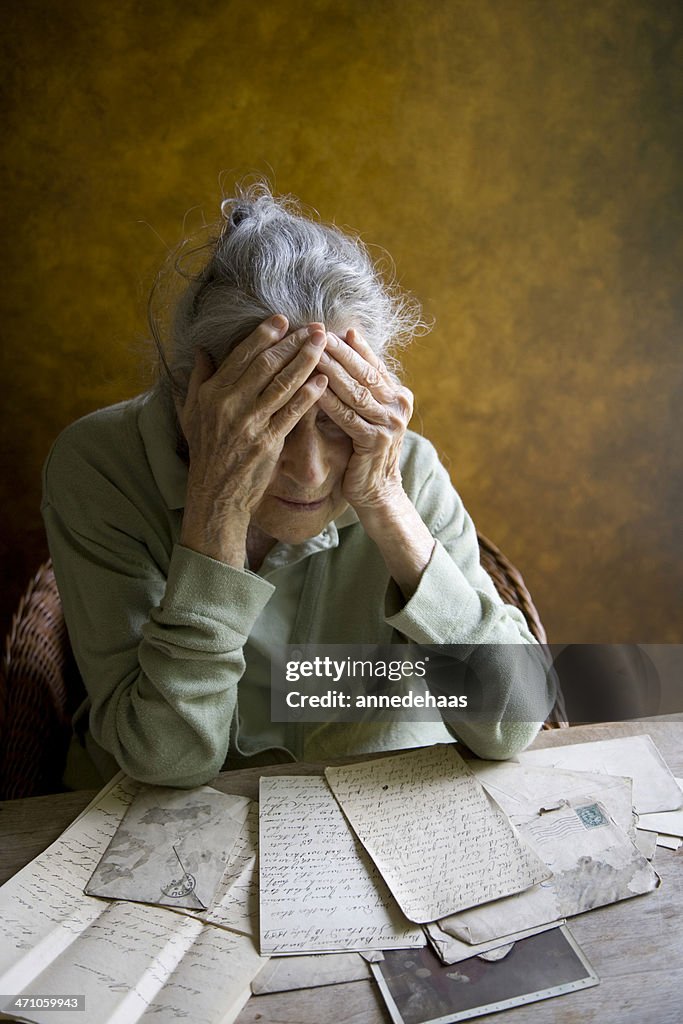 Female Reminiscing Elderly Woman Reminiscing Over Old Letters And Photos High-Res Stock ...