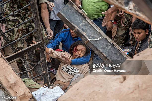 Emergency rescue workers find a survivor in the debris of Dharara tower after it collapsed on April 25, 2015 in Kathmandu, Nepal. More than 100...