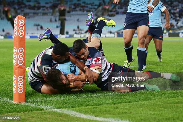 Rob Horne of the Waratahs beats the defence to score a try in the corner during the round 11 Super Rugby match between the Waratahs and the Rebels at...