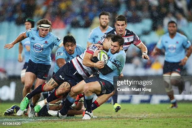 Adam Ashley-Cooper of the Waratahs is tackled during the round 11 Super Rugby match between the Waratahs and the Rebels at ANZ Stadium on April 25,...