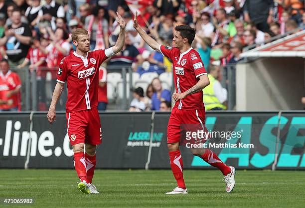 Tim Kleindienst of Cottbus jubilates with team mate Uwe Moehrle after scoring the second goal during the third league match between FC Energie...