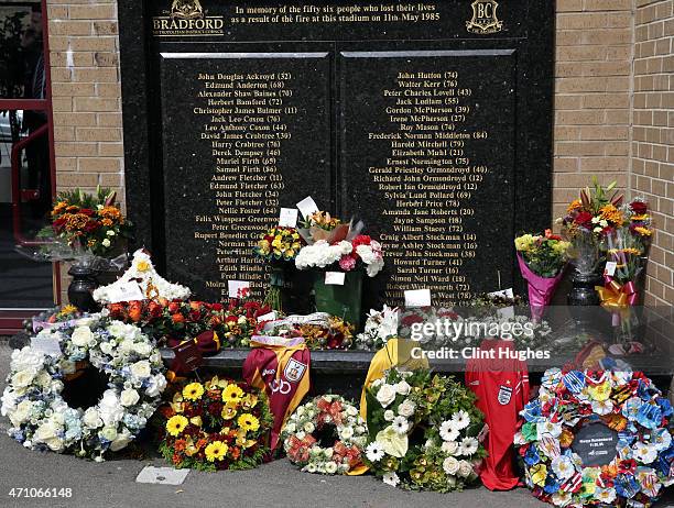 Floral tributes are laid at the Valley Parade Fire Memorial on the thirtieth anniversary of the Valley Parade fire during the Sky Bet League One...