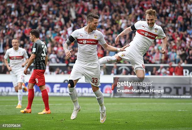 Daniel Ginczek of Stuttgart celebrates with his team-mate Alexandru Maxim of Stuttgart after scoring his team's first goal during the Bundesliga...