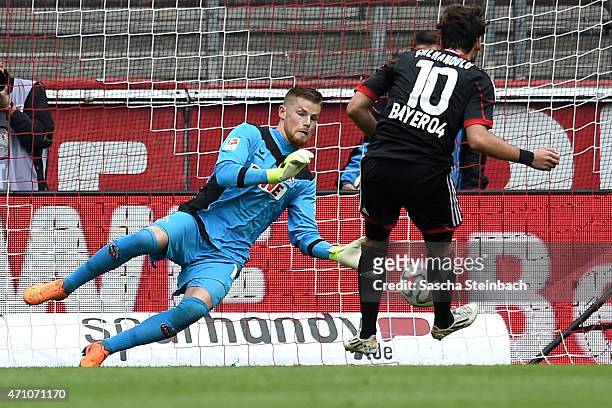 Goalkeeper Timo Horn of Koeln saves the ball from a penalty of Hakan Calhanoglu of Leverkusen during the Bundesliga match between 1. FC Koeln and...