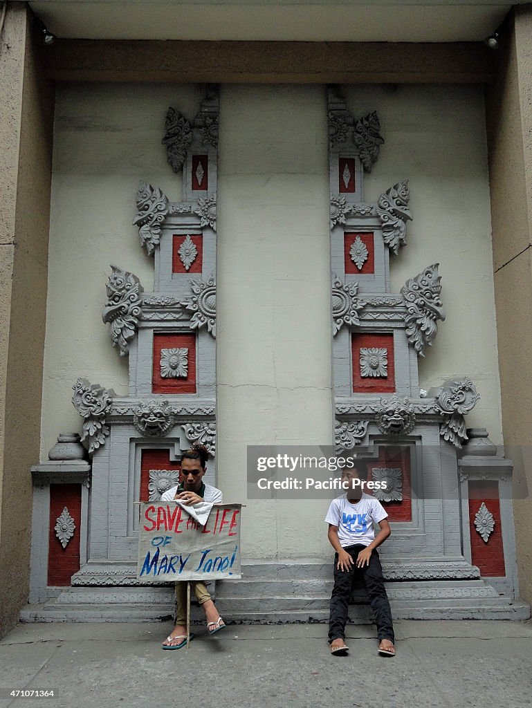 Filipino activists take a rest during a rally outside the...