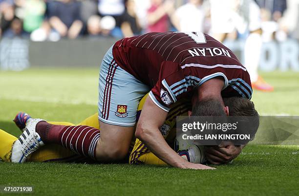 West Ham United's English midfielder Kevin Nolan hugs West Ham United's Spanish goalkeeper Adrian after he saved a penalty from Queens Park Rangers...