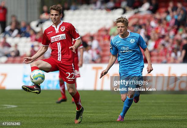 Marco Holz of Cottbus battles for the ball with Royal Bentley Baxter Bahn of Stuttgart during the third league match between FC Energie Cottbus and...