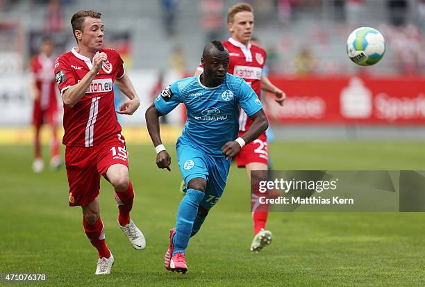 Nikolas Ledgerwood of Cottbus battles for the ball with Randy Edwini Bonsu of Stuttgart during the third league match between FC Energie Cottbus and...