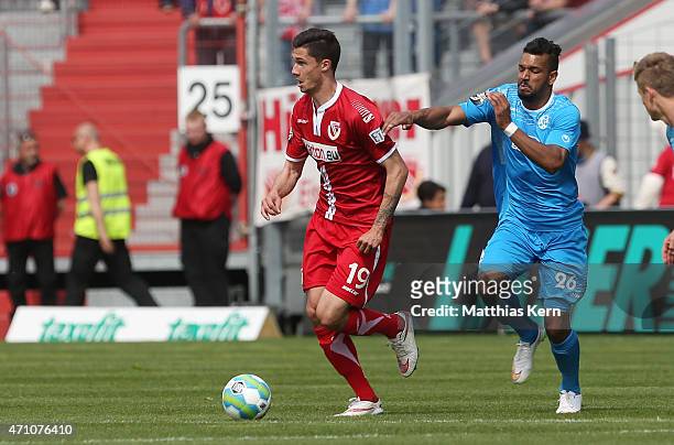Tim Kleindienst of Cottbus battles for the ball with Royal Dominique Fennell of Stuttgart during the third league match between FC Energie Cottbus...