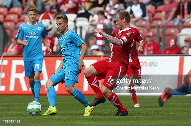 Thomas Huebner of Cottbus battles for the ball with Gerrit Mueller of Stuttgart during the third league match between FC Energie Cottbus and SV...