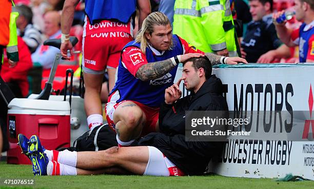 Gloucester wing Jonny May is consoled by replacement Richard Hibbard after leaving the pitch injured during the first half during the Aviva...