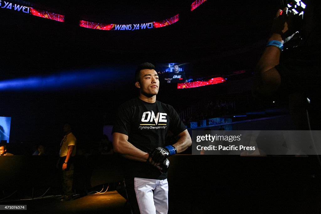 Wang Ya Wei walks on to the stage before his fight at the...