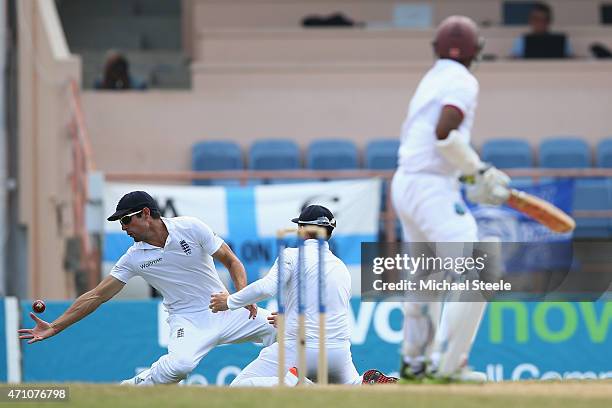 Alastair Cook of England takes a catch at first slip to claim the wicket of Shivnarine Chanderpaul of West Indies off the bowling of James Anderson...