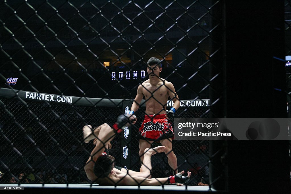 Nicholas Lee of Singapore falls after a knock out punch from...