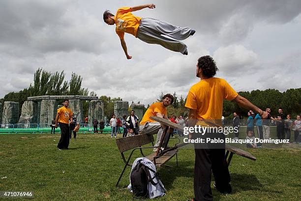 Man bounce on table near Sacrilege, an inflatable sculpture of Stonehenge created by British artist Jeremy Deller, at Parque del Soto on April 25,...