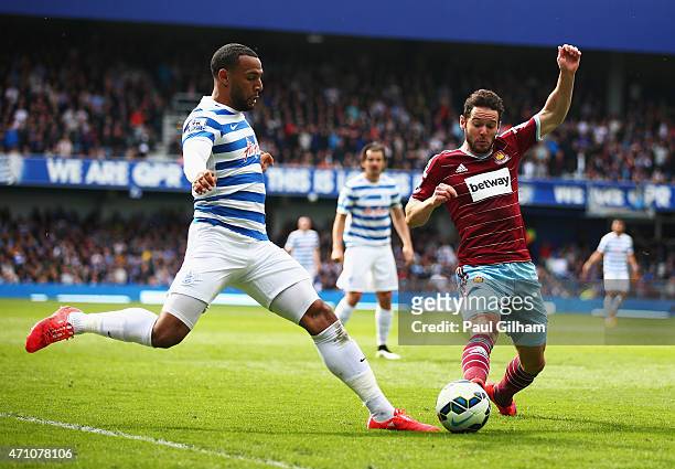 Matt Philips of QPR and Aaron Cresswell of West Ham tussle for the ball during the Barclays Premier League match between Queens Park Rangers and West...