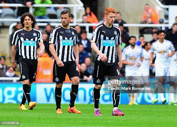 Fabricio Coloccini, Ryan Taylor and Jack Colback of Newcastle United walk back to the half way line after the second goal during the Barclays Premier...