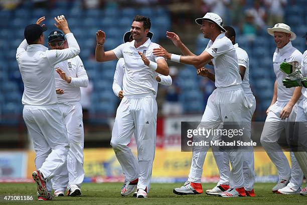 James Anderson of England celebrates alongside Stuart Broad and Gary Ballance after running out Jason Holderof West Indies during day five of the 2nd...